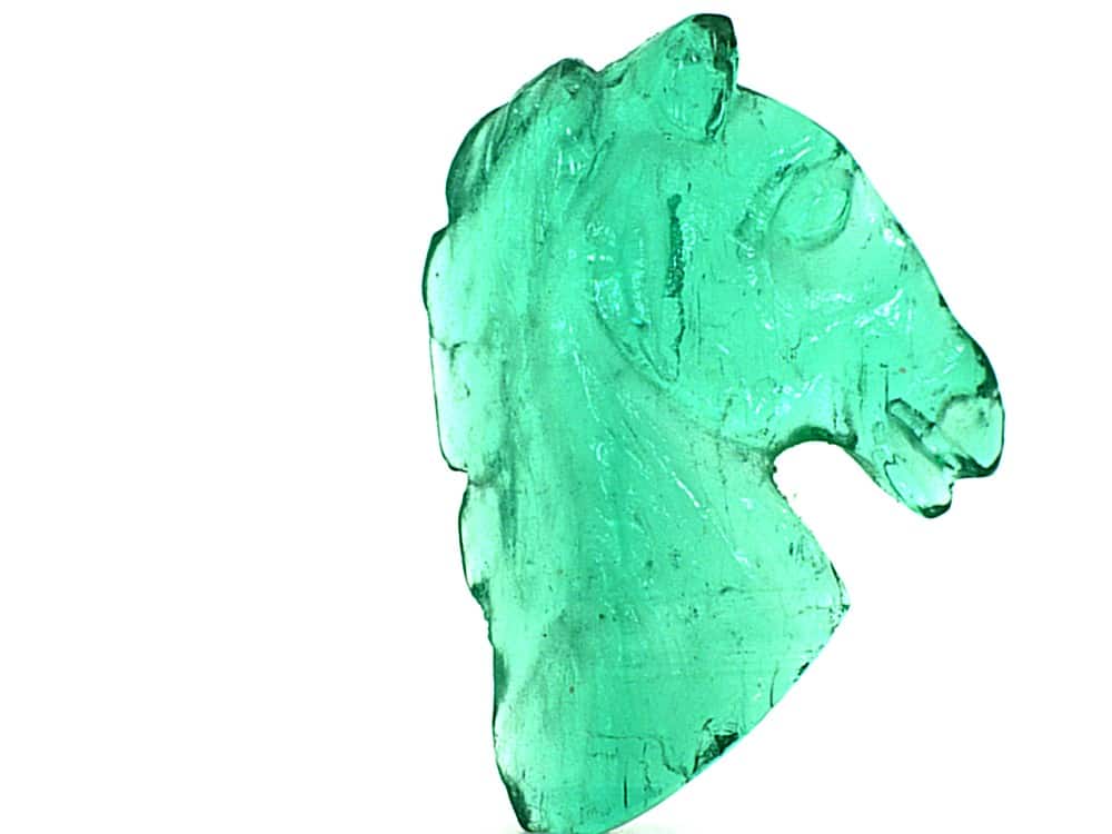 Elegant Colombian emerald carved horse pendant for jewelry.