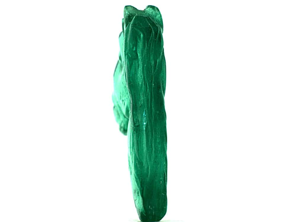 Vivid green Colombian emerald gemstone with natural inclusions.